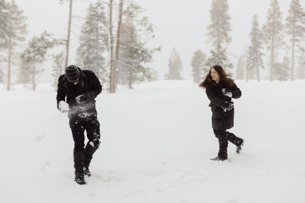 couple having a snowball fight